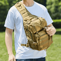 Person wearing a tan tactical sling bag outdoors
