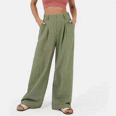 Person wearing green wide-leg pants on a white background