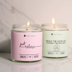 Two candles with humorous labels on a light background