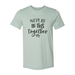 Mint green t-shirt with 'We're all in this together' text on a white background