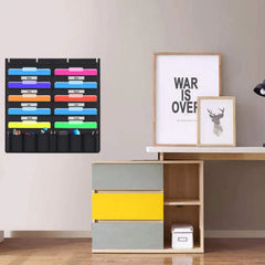 Colorful file organizer hanging on a wall above a wooden cabinet with decorative items.