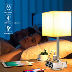 Table lamp with clock and USB ports on a bedside table, with a person sleeping in the background.