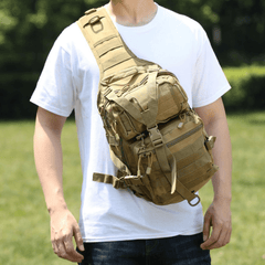 Person wearing a tan tactical sling bag outdoors