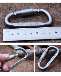 Silver carabiner with measurement scale on a textured surface