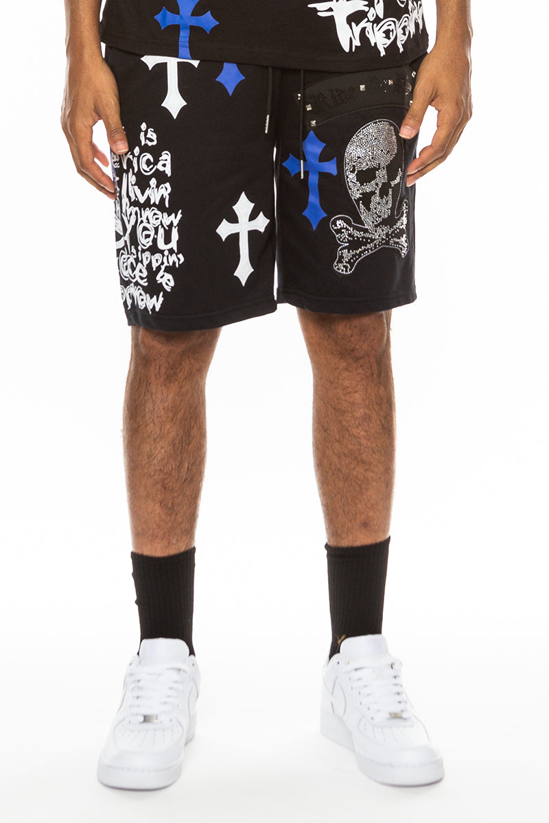 Black shorts with graphic designs worn by a person on a white background