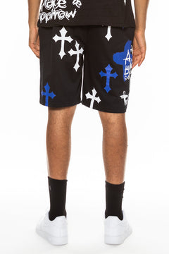 Person wearing black shorts with white and blue designs on a white background