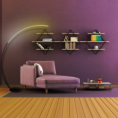 Modern living room with a purple armchair, floor lamp, and wall shelves against a purple wall.