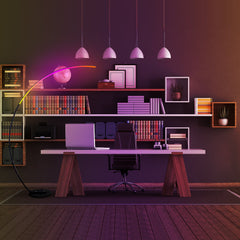 Modern office setup with a desk, chair, and shelves filled with books and decor.