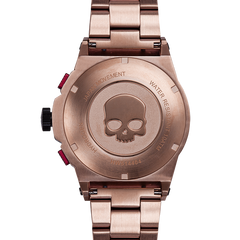 Rose gold watch with skull design on the back, brand 'HORUS' visible