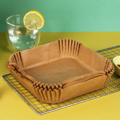 Brown paper inserts on a cooling rack with a glass of water and lemon slice in the background.
