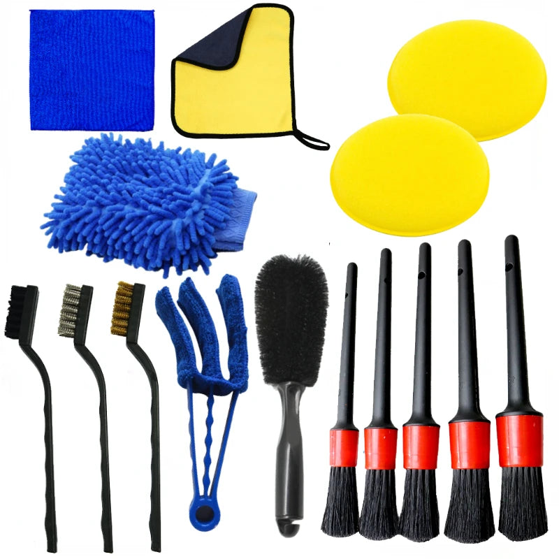 Collection of car cleaning tools including brushes, sponges, and cloths on a white background