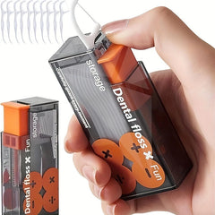 Hand holding a transparent container with orange accents labeled 'Dental floss x Fun' against a white background.