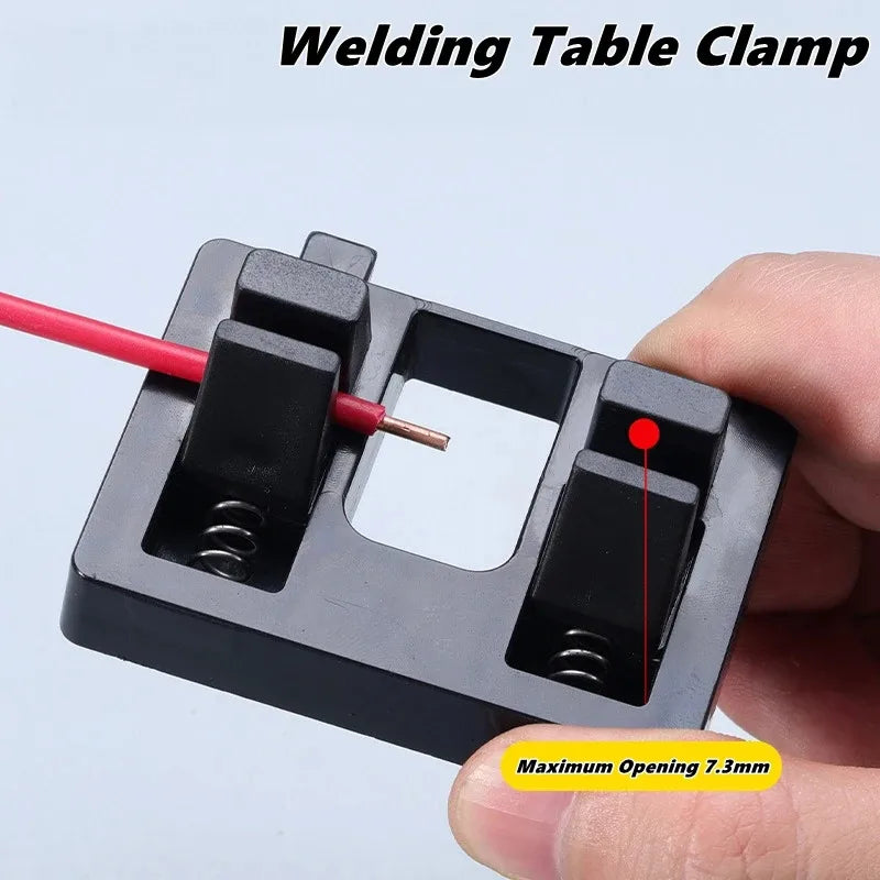 Welding table clamp held by a hand with a light background