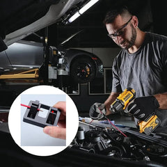 Mechanic working on a car with a close-up of a welding clamp in the foreground.
