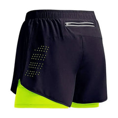 Black athletic shorts with a neon green inner lining on a white background