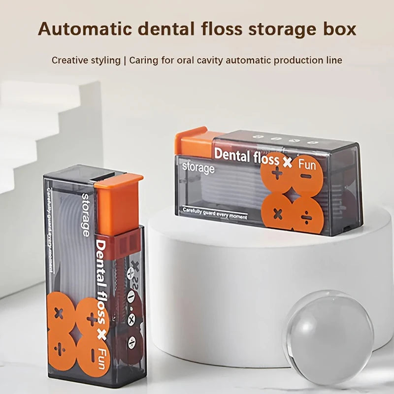 Two automatic dental floss storage boxes with orange accents on a white surface.
