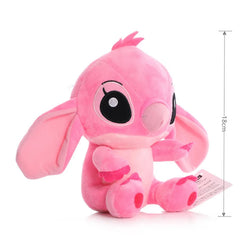 Pink plush toy with black eyes on a white background