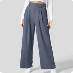 Person wearing blue wide-leg pants on a light gray background