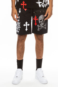Person wearing black shorts with red, white, and gray designs on a white background