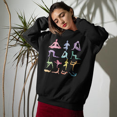 Woman wearing a black sweatshirt with colorful yoga pose illustrations against a neutral background.