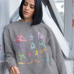 Woman wearing a gray sweatshirt with colorful yoga pose illustrations.