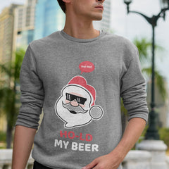 Person wearing a gray sweatshirt with a Santa Claus graphic and text 'Ho! Ho! Ho! Hold My Beer' in an urban setting.