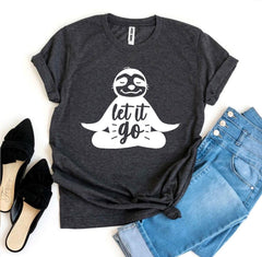 Dark gray t-shirt with a sloth graphic and 'let it go' text, paired with jeans and shoes on a white background.