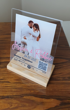 Acrylic photo plaque with wooden stand displaying a couple and event details.