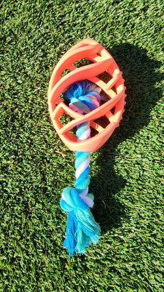 Dog toy with a rope on grass