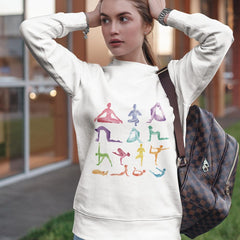 Woman wearing a white sweatshirt with colorful yoga pose illustrations.