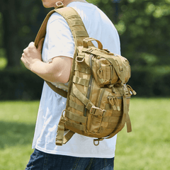 Person wearing a tan tactical backpack outdoors