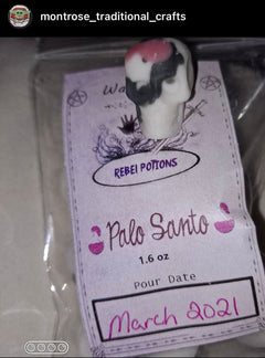 Palo Santo bag with a label and small wax skull on a pale background