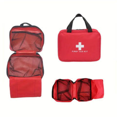 Red first aid kit with open compartments on a white background