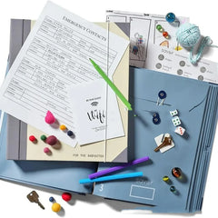 Collection of stationery items including a blue folder, papers, and small objects on a white background