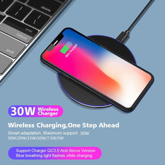 Wireless charger with smartphone on a blue surface, showing charging process.