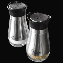 Salt and pepper shakers with black lids on a black background