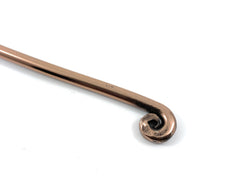 Copper spoon handle on a white background