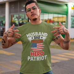 Man wearing a green t-shirt with patriotic text in an outdoor setting