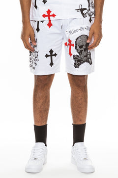 Person wearing white shorts with black and red designs on a white background